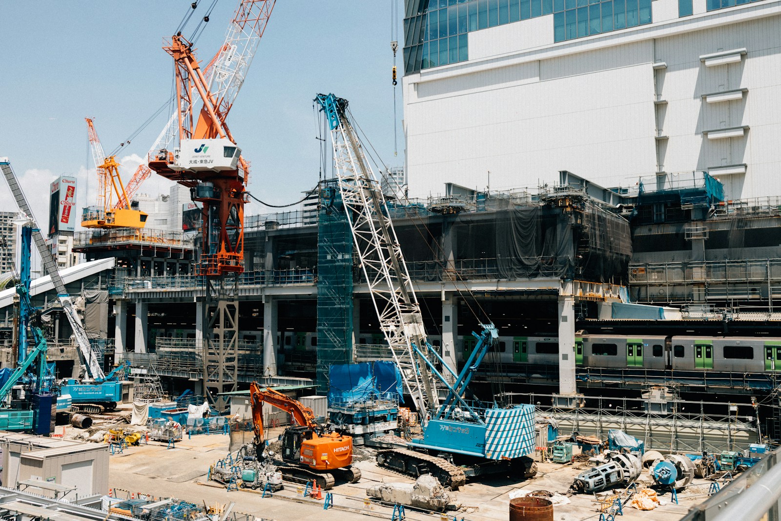 Construction site with cranes and heavy machinery.